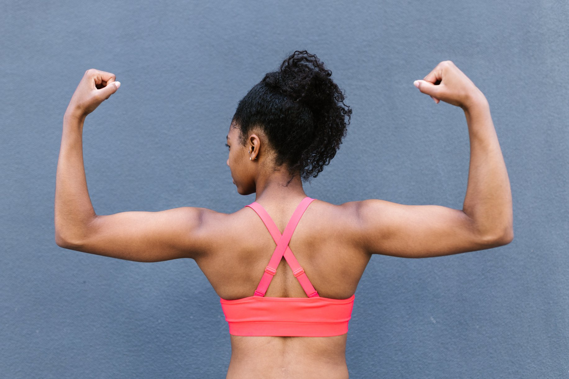 A Woman in Pink Top Flexing