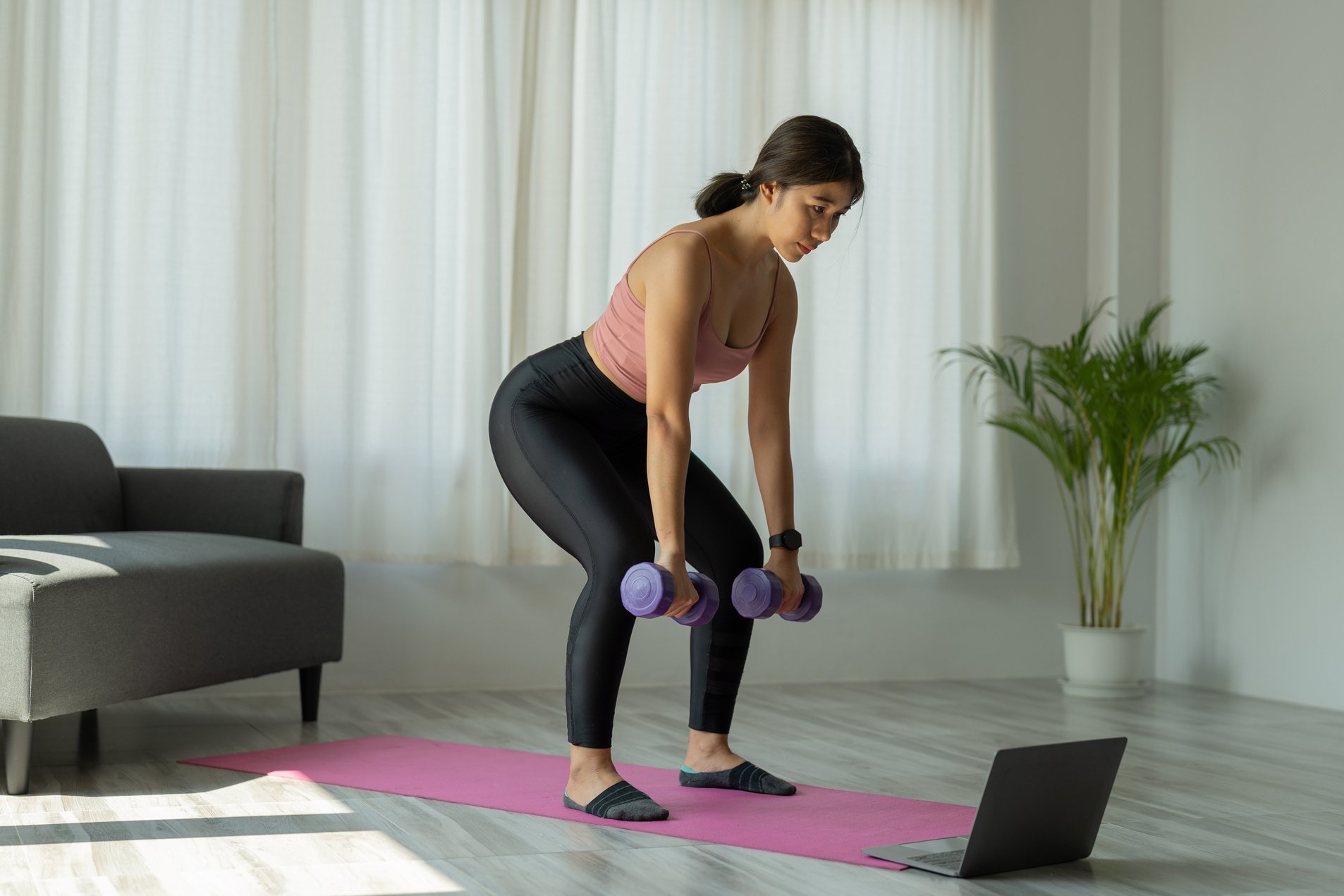 Young woman is exercising yoga at home. Fitness, workout, he